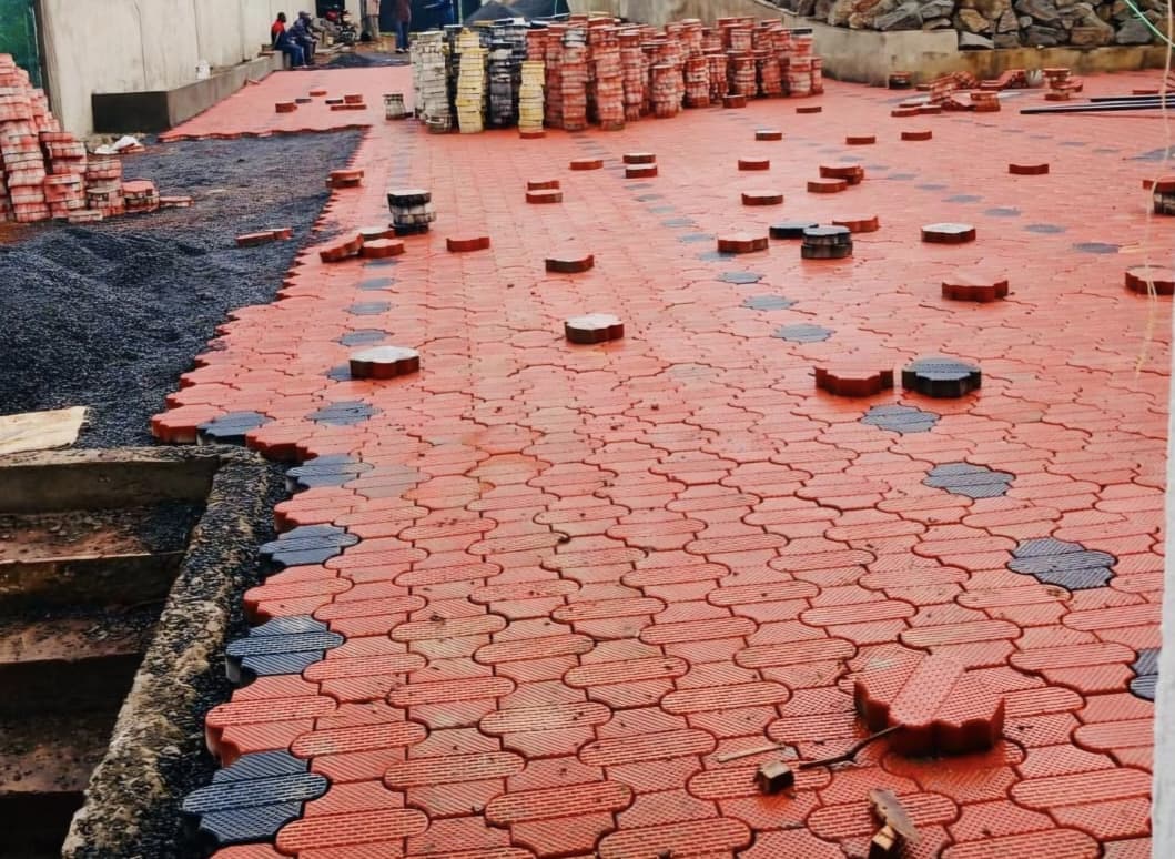 Red courtblock cabro being laid during an installation