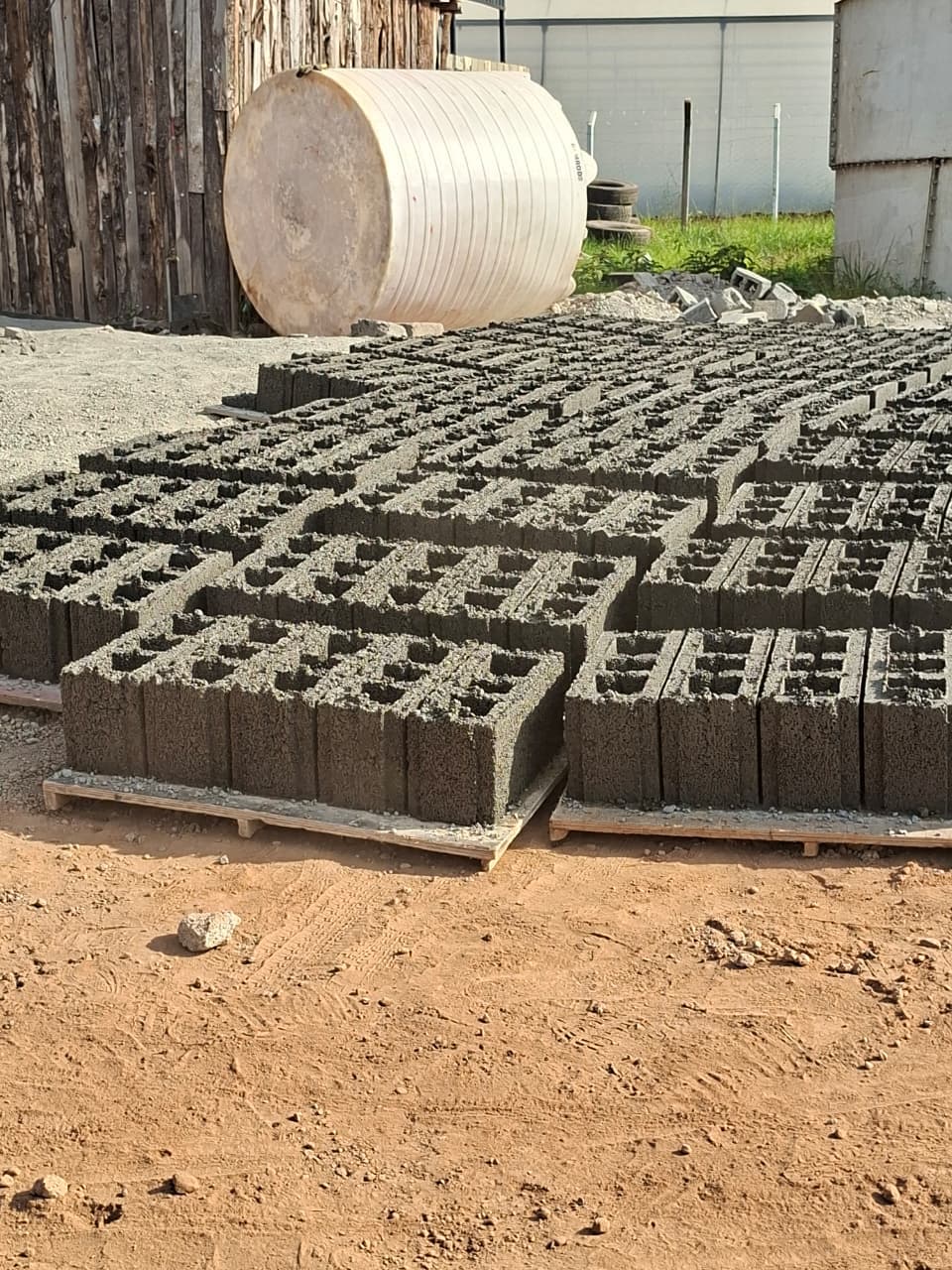 Hollow walling blocks arranged during curing for consistent production quality.