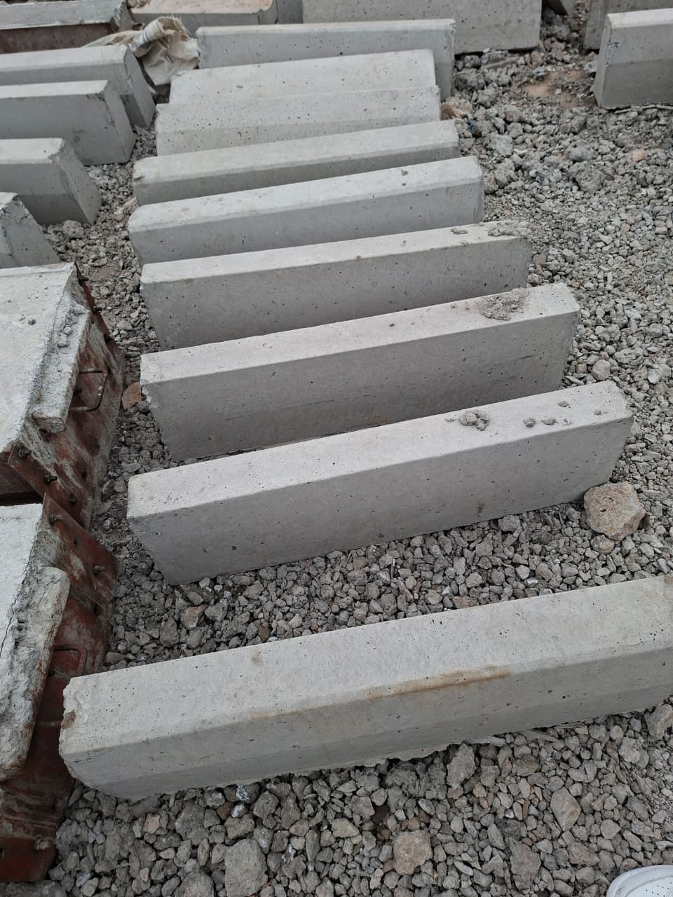 Straight precast kerbstones ready for neat, durable road and driveway edging in bulk quantities