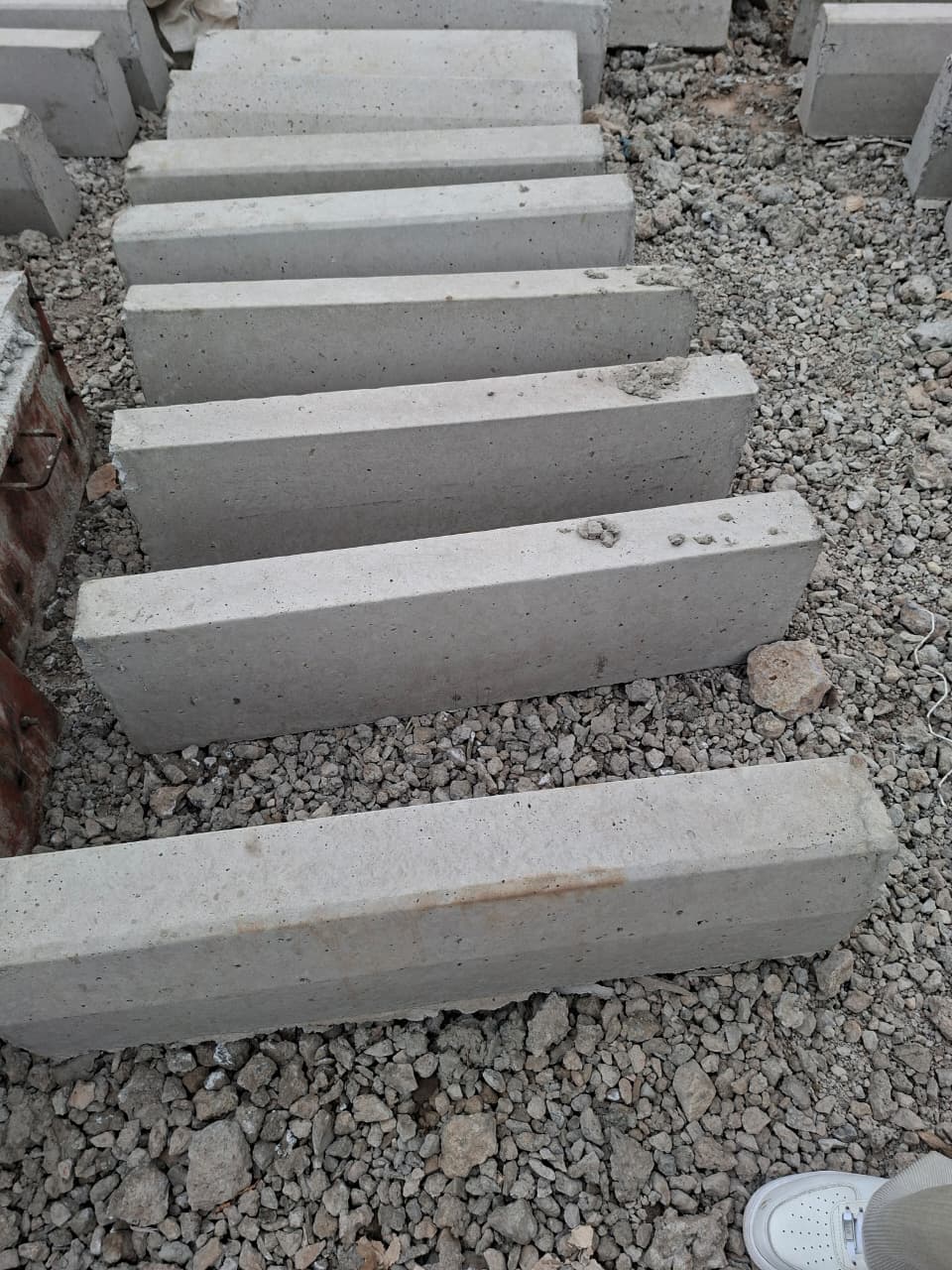 Straight precast kerbstones ready for neat, durable road and driveway edging in bulk quantities