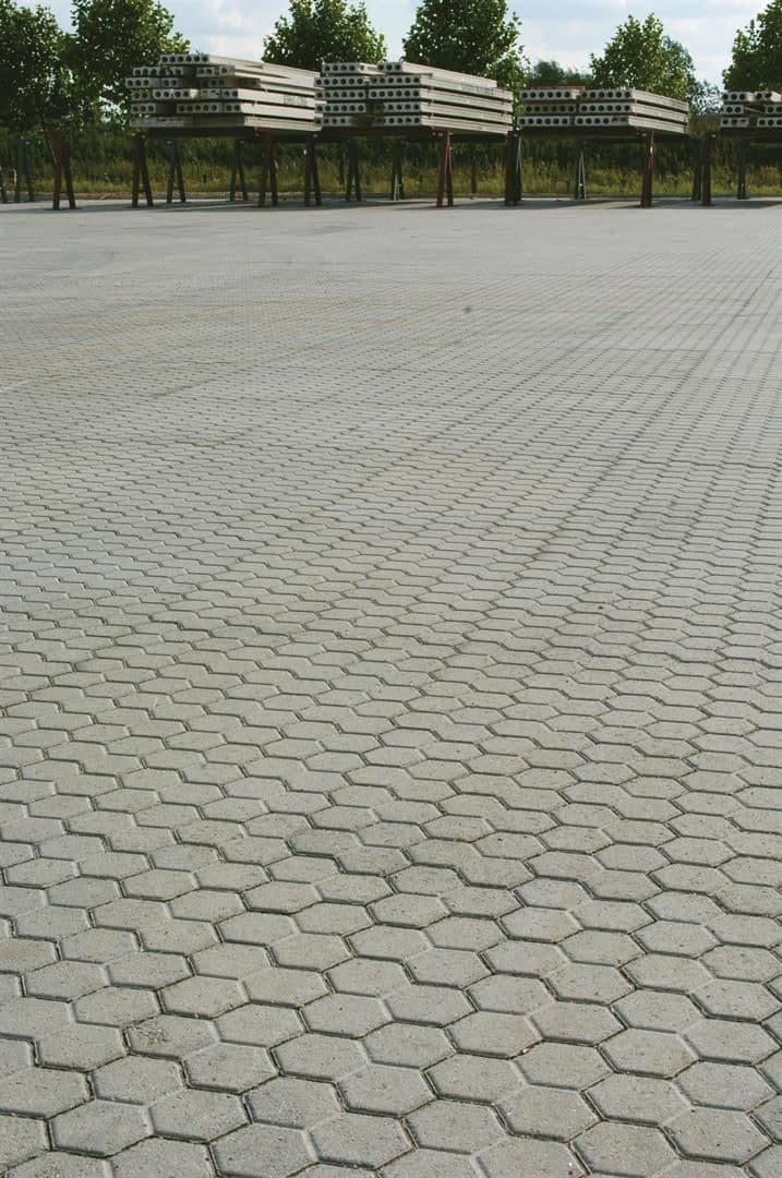 Large commercial area paved with grey hexagonal cabro blocks.